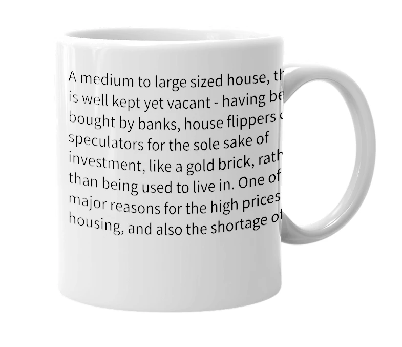 White mug with the definition of 'gold bricked house'