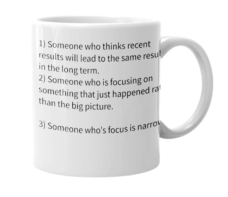 White mug with the definition of 'prisoner of the moment'