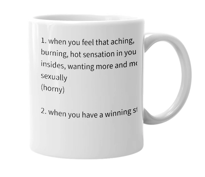 White mug with the definition of 'on fire'