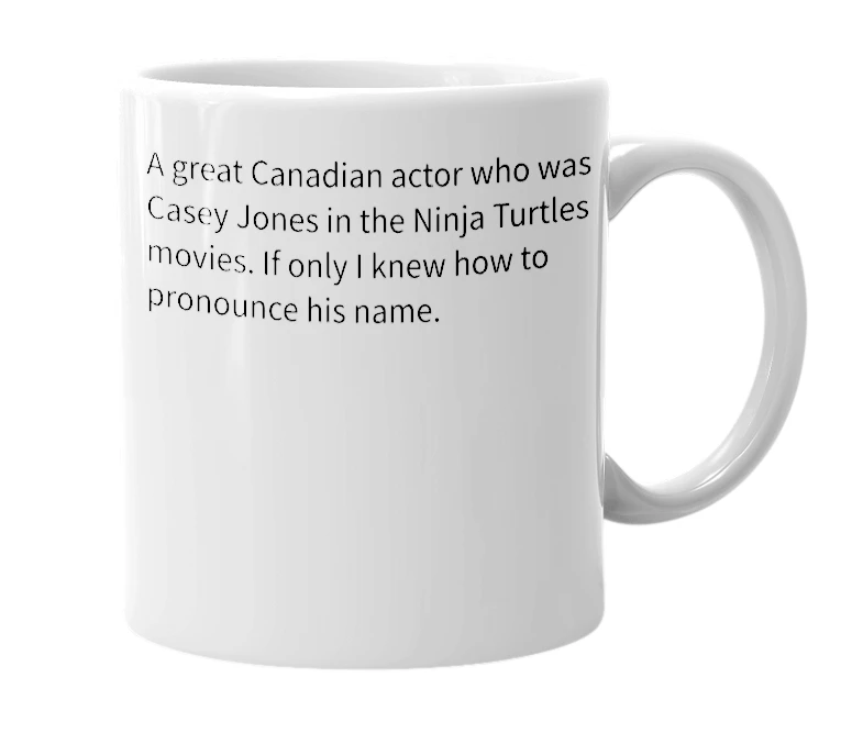White mug with the definition of 'Elias Koteas'