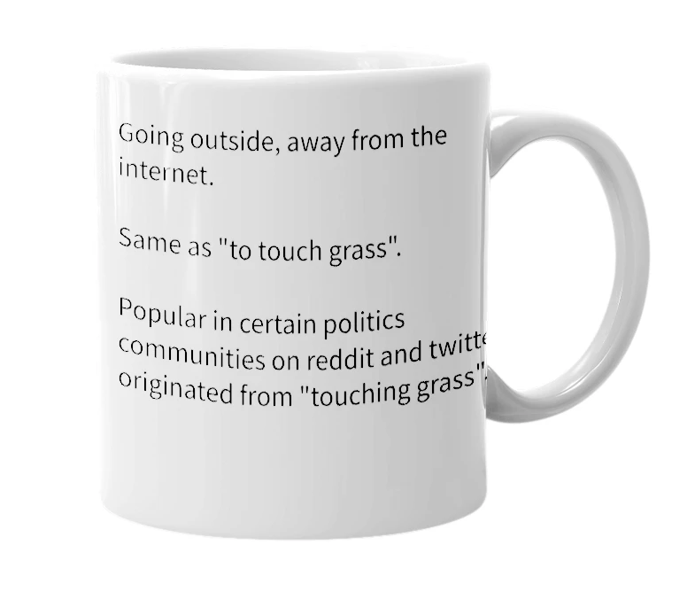 White mug with the definition of 'eat grass'