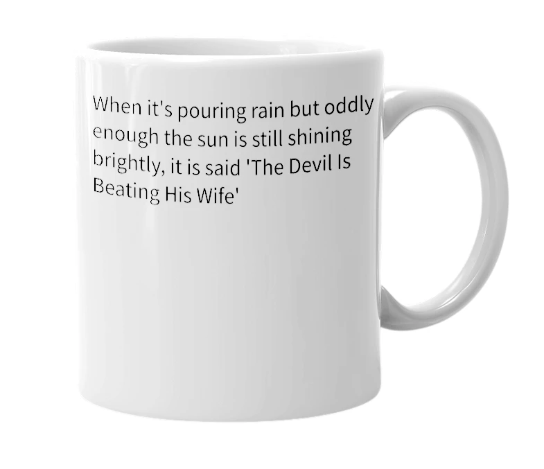 White mug with the definition of 'devil beating his wife'
