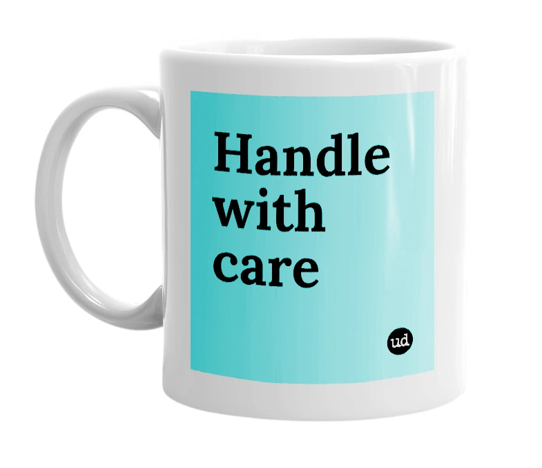White mug with 'Handle with care' in bold black letters