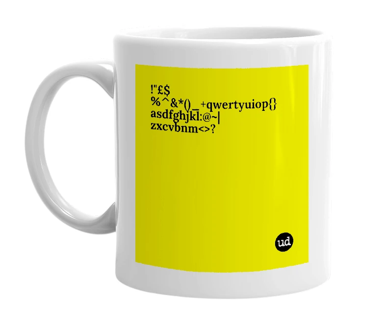 White mug with '!"£$%^&*()_+qwertyuiop{}asdfghjkl:@~|zxcvbnm<>?' in bold black letters