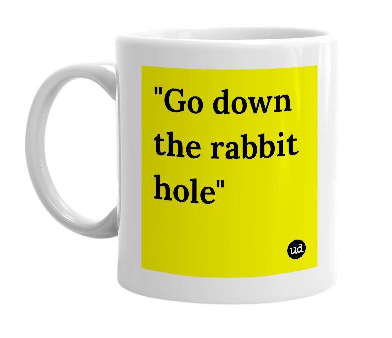 White mug with '"Go down the rabbit hole"' in bold black letters