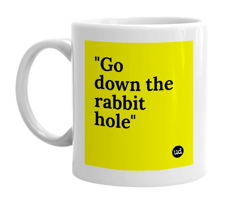 White mug with '"Go down the rabbit hole"' in bold black letters