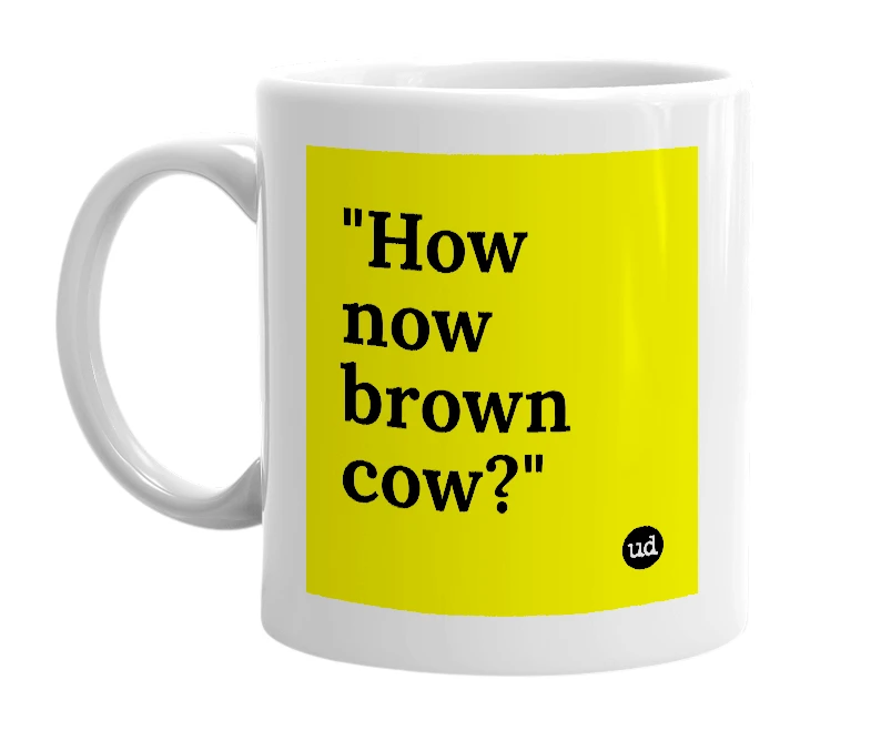 White mug with '"How now brown cow?"' in bold black letters