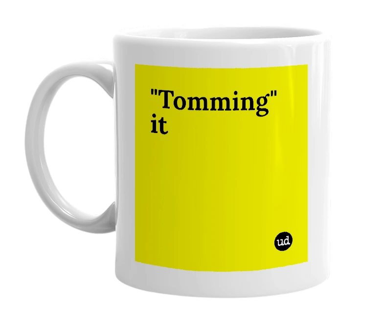 White mug with '"Tomming" it' in bold black letters