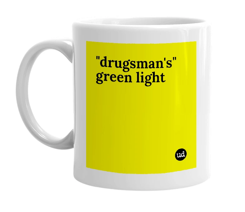 White mug with '"drugsman's" green light' in bold black letters