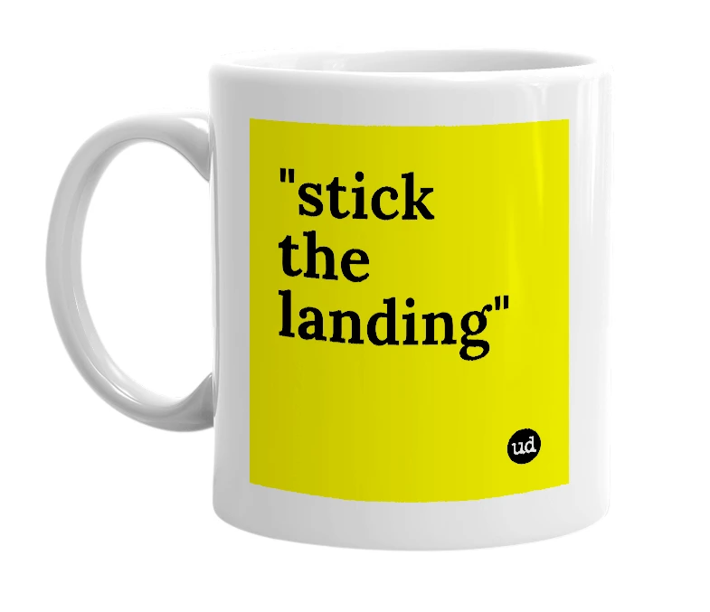 White mug with '"stick the landing"' in bold black letters
