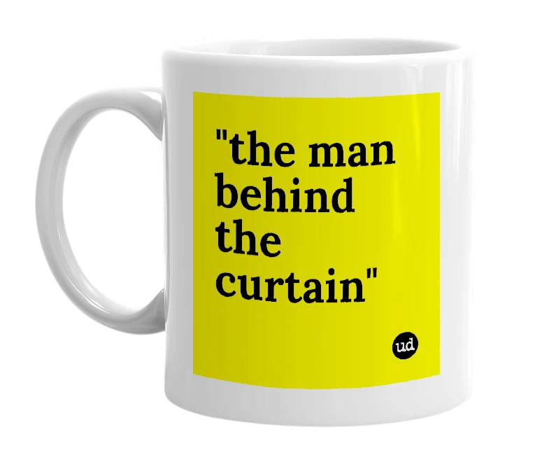 White mug with '"the man behind the curtain"' in bold black letters