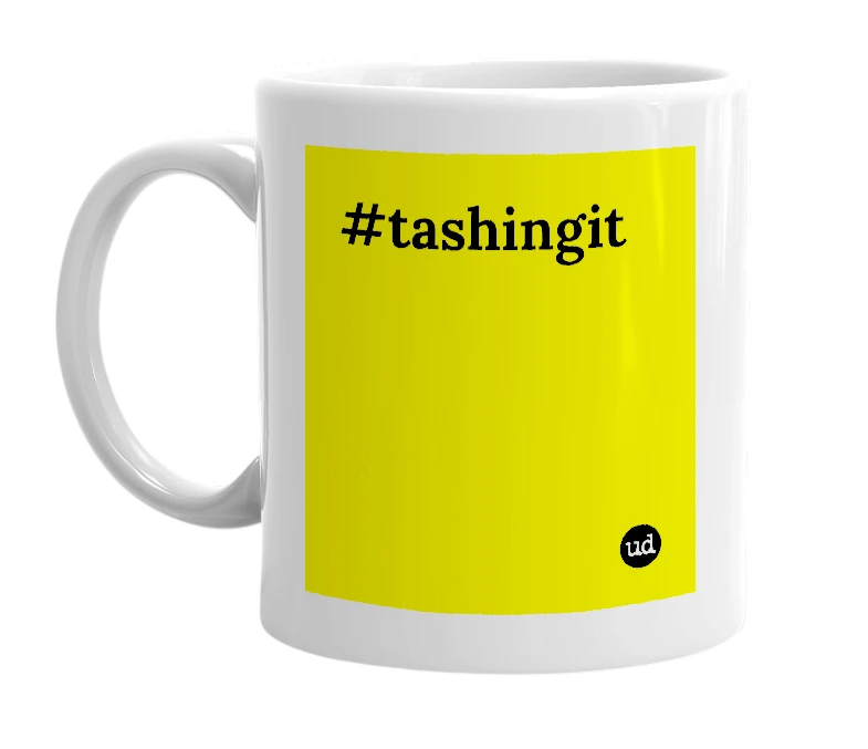 White mug with '#tashingit' in bold black letters