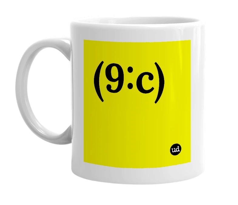 White mug with '(9:c)' in bold black letters