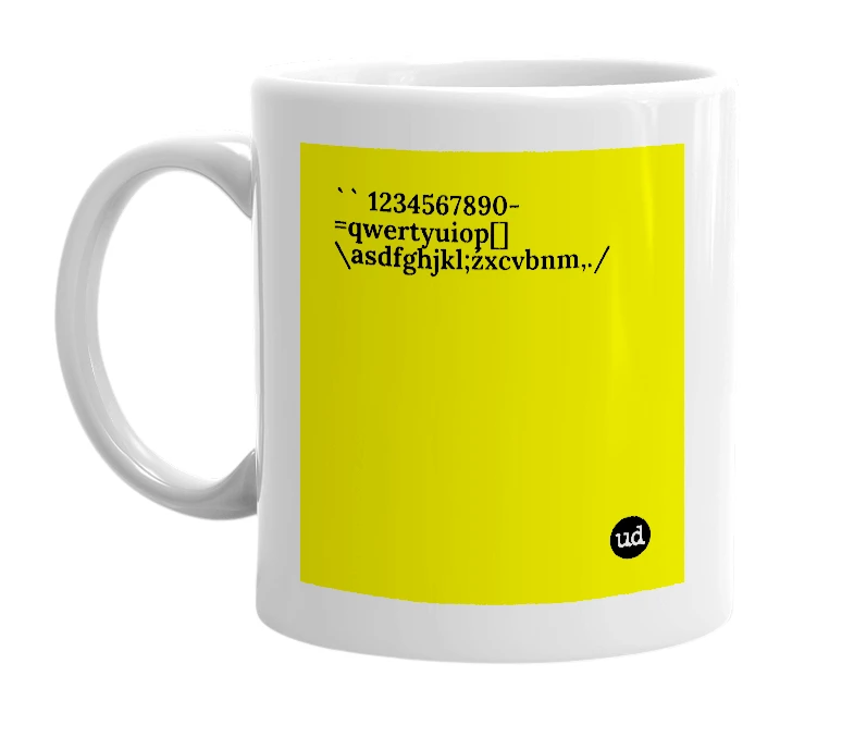 White mug with '`` 1234567890-=qwertyuiop[]\asdfghjkl;źxcvbnm,./' in bold black letters