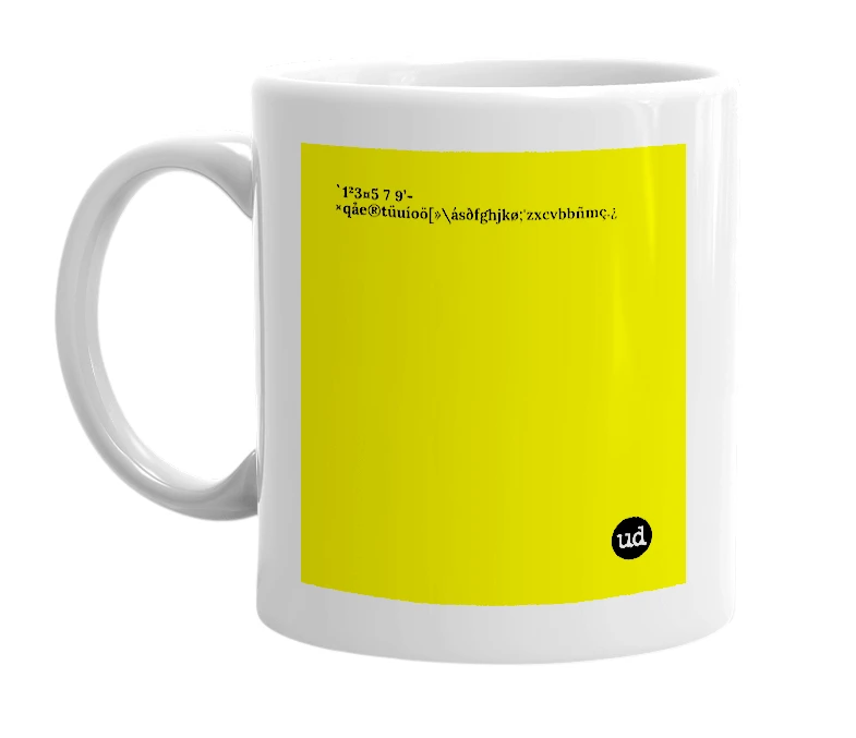 White mug with '`1²3¤5 7 9’-×qåe®tüuíoö[»\ásðfghjkø;'zxcvbbñmç.¿' in bold black letters