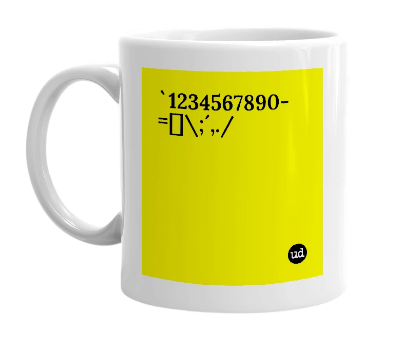 White mug with '`1234567890-=[]\;´,./' in bold black letters