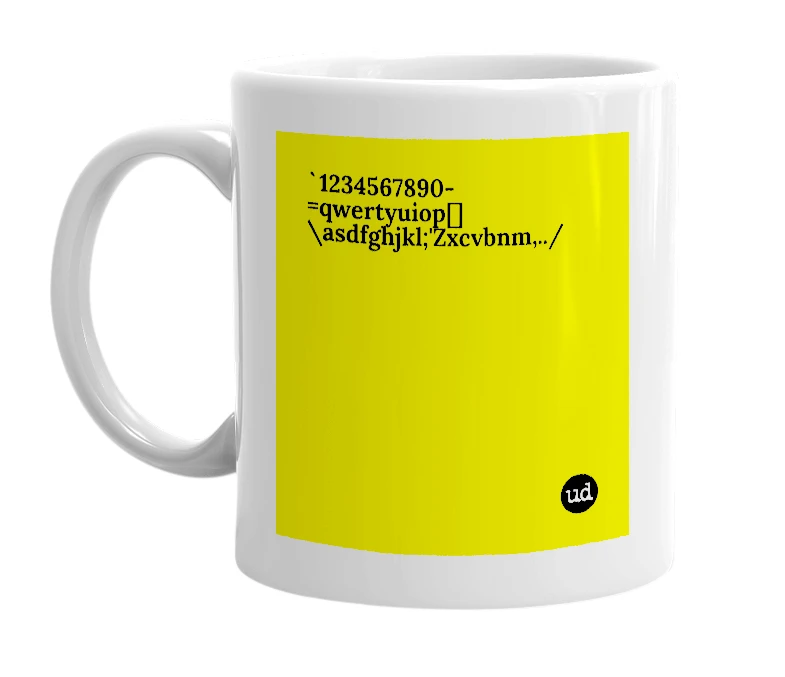 White mug with '`1234567890-=qwertyuiop[]\asdfghjkl;'Zxcvbnm,../' in bold black letters