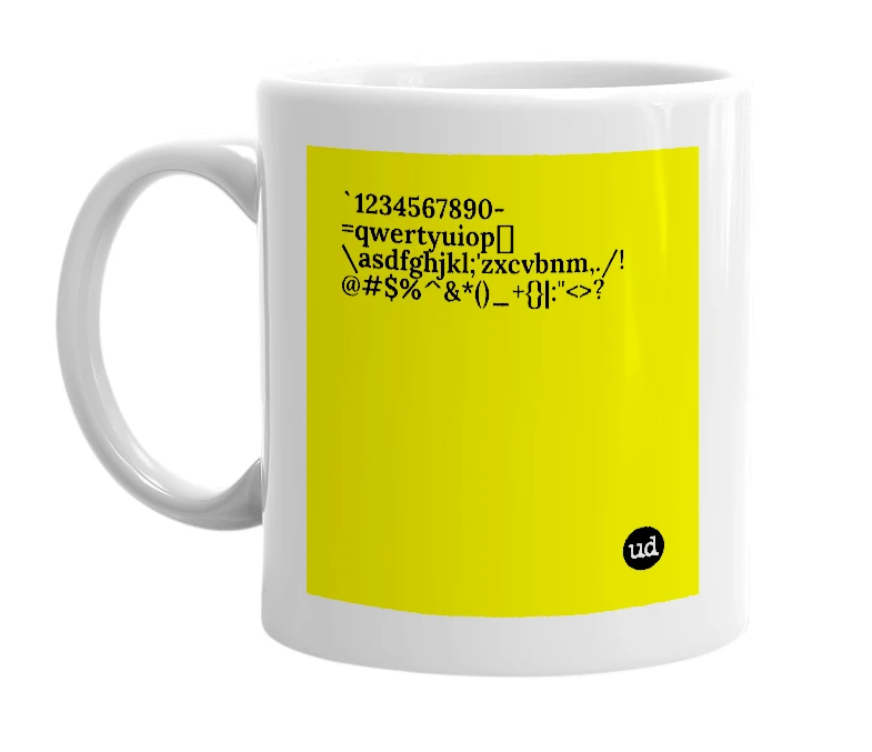 White mug with '`1234567890-=qwertyuiop[]\asdfghjkl;'zxcvbnm,./!@#$%^&*()_+{}|:"<>?' in bold black letters
