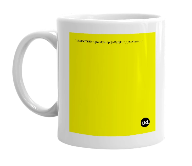 White mug with '`1234567890-=qwertyuiop[]sdfghjkl;'\\zxcvbnm,./' in bold black letters