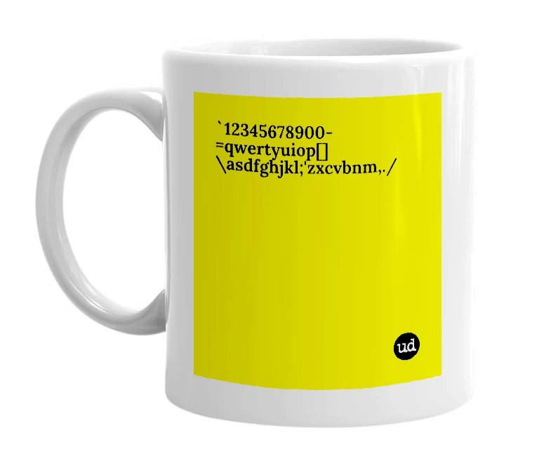 White mug with '`12345678900-=qwertyuiop[]\asdfghjkl;'zxcvbnm,./' in bold black letters