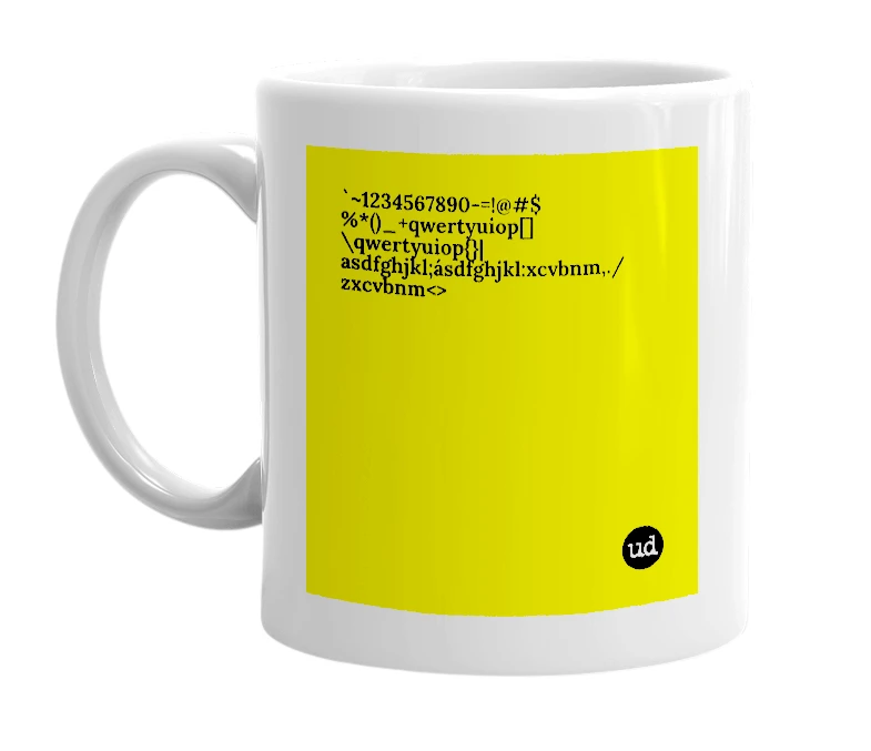 White mug with '`~1234567890-=!@#$%*()_+qwertyuiop[]\qwertyuiop{}|asdfghjkl;ásdfghjkl:xcvbnm,./zxcvbnm<>' in bold black letters