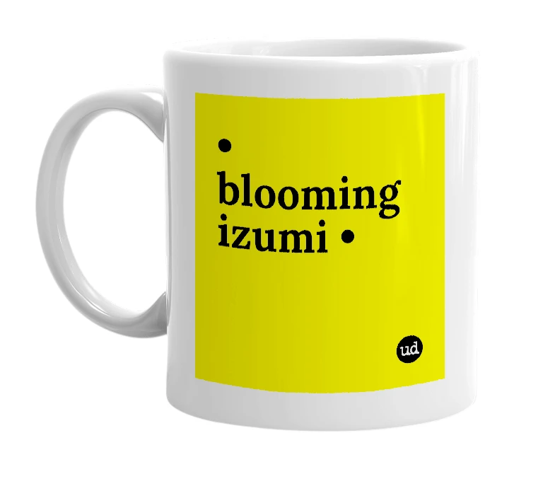 White mug with '• blooming izumi •' in bold black letters