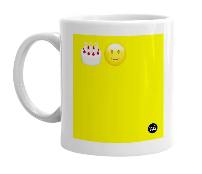 White mug with '🎂🙂' in bold black letters