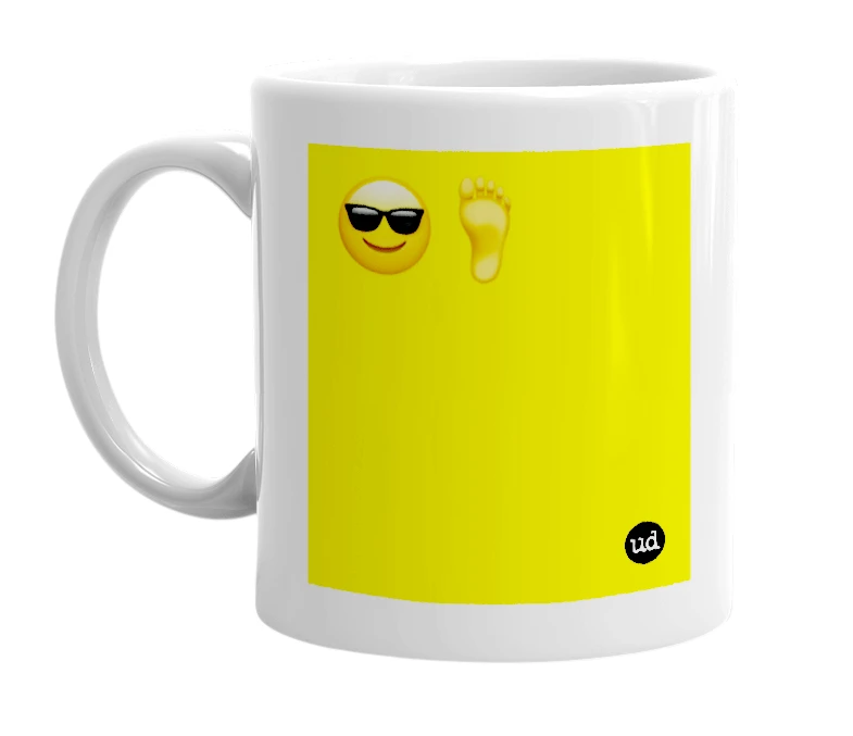 White mug with '😎🦶' in bold black letters