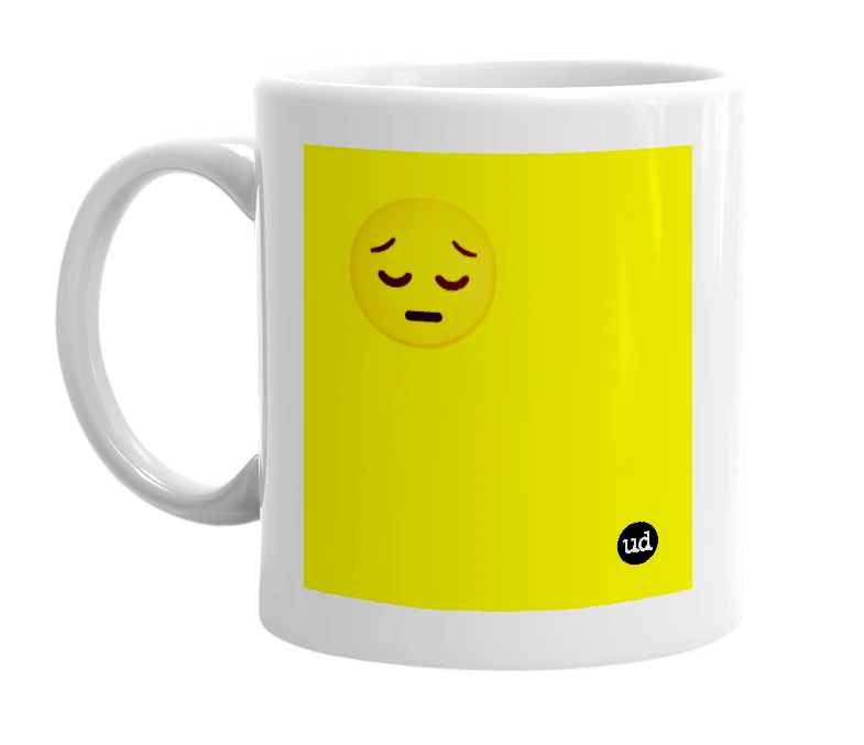 White mug with '😔' in bold black letters