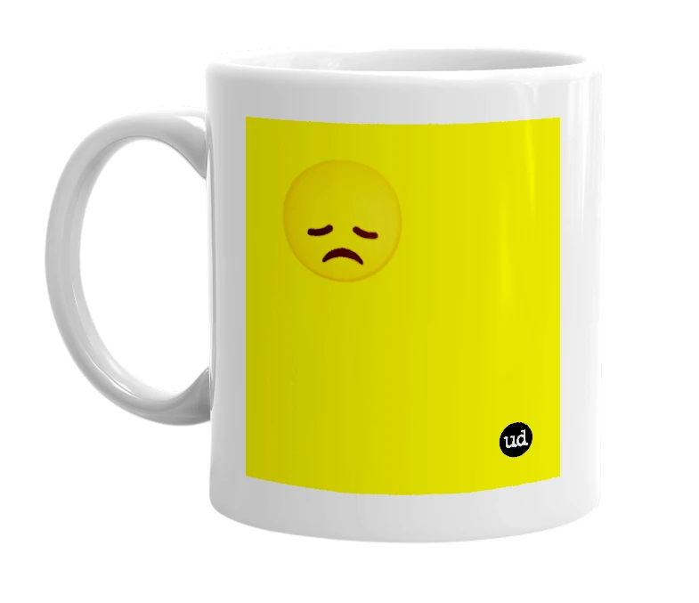 White mug with '😞' in bold black letters