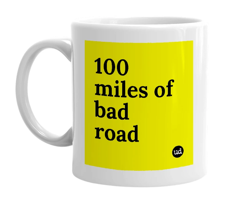 White mug with '100 miles of bad road' in bold black letters