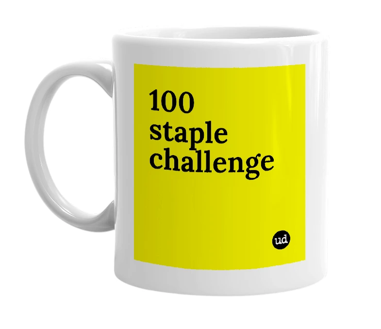 White mug with '100 staple challenge' in bold black letters