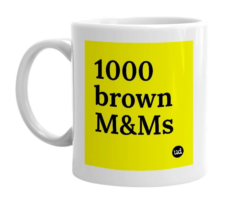 White mug with '1000 brown M&Ms' in bold black letters