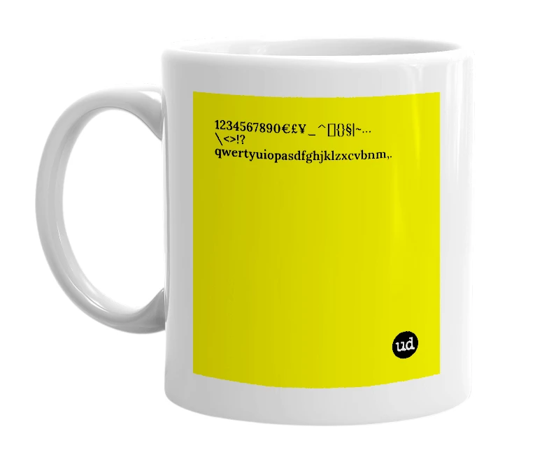 White mug with '1234567890€£¥_^[]{}§|~…\<>!?qwertyuiopasdfghjklzxcvbnm,.' in bold black letters