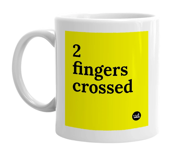 White mug with '2 fingers crossed' in bold black letters