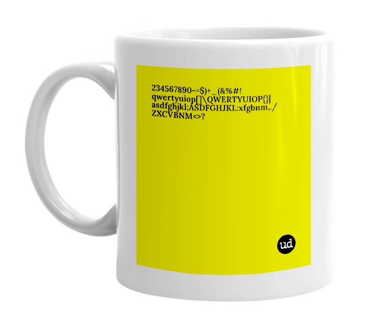 White mug with '234567890-=$)+_(&%#!qwertyuiop[]\QWERTYUIOP{}|asdfghjkl;ÁSDFGHJKL:xfgbnm,./ZXCVBNM<>?' in bold black letters