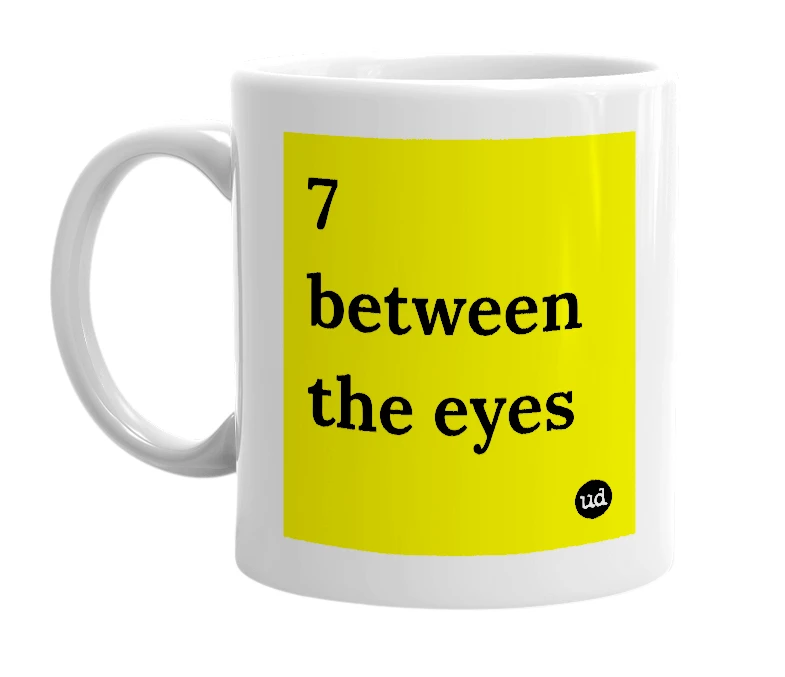 White mug with '7 between the eyes' in bold black letters