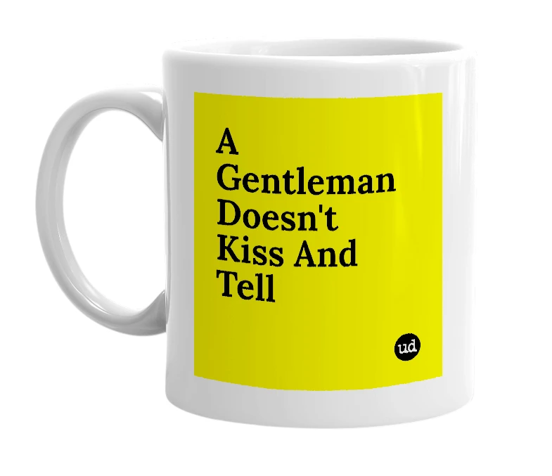 White mug with 'A Gentleman Doesn't Kiss And Tell' in bold black letters