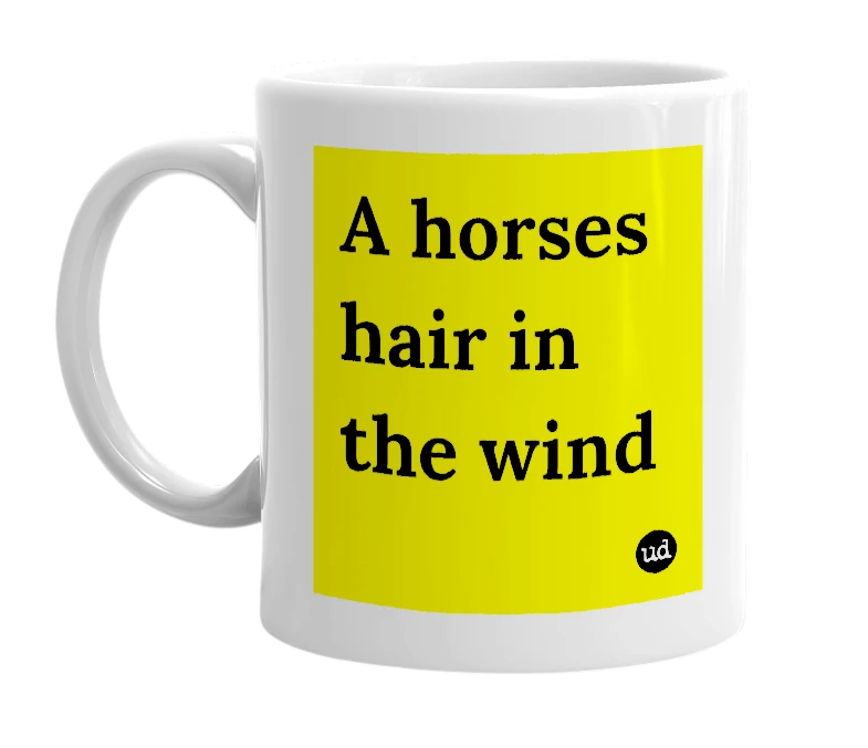 White mug with 'A horses hair in the wind' in bold black letters