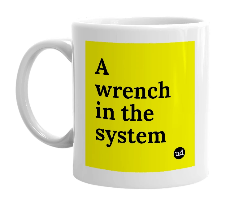 White mug with 'A wrench in the system' in bold black letters