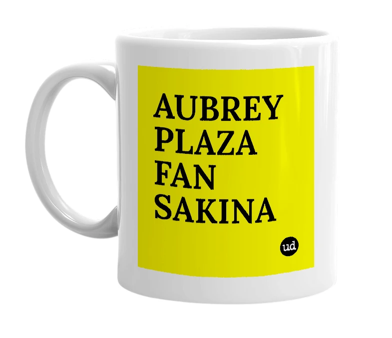 White mug with 'AUBREY PLAZA FAN SAKINA' in bold black letters
