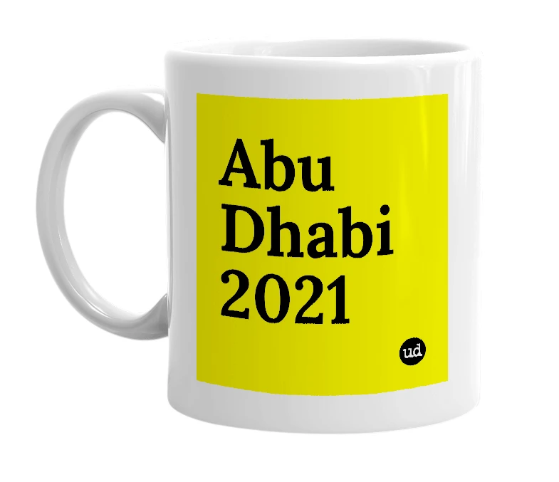 White mug with 'Abu Dhabi 2021' in bold black letters