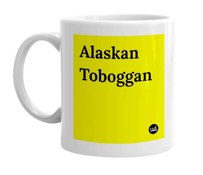 White mug with 'Alaskan Toboggan' in bold black letters