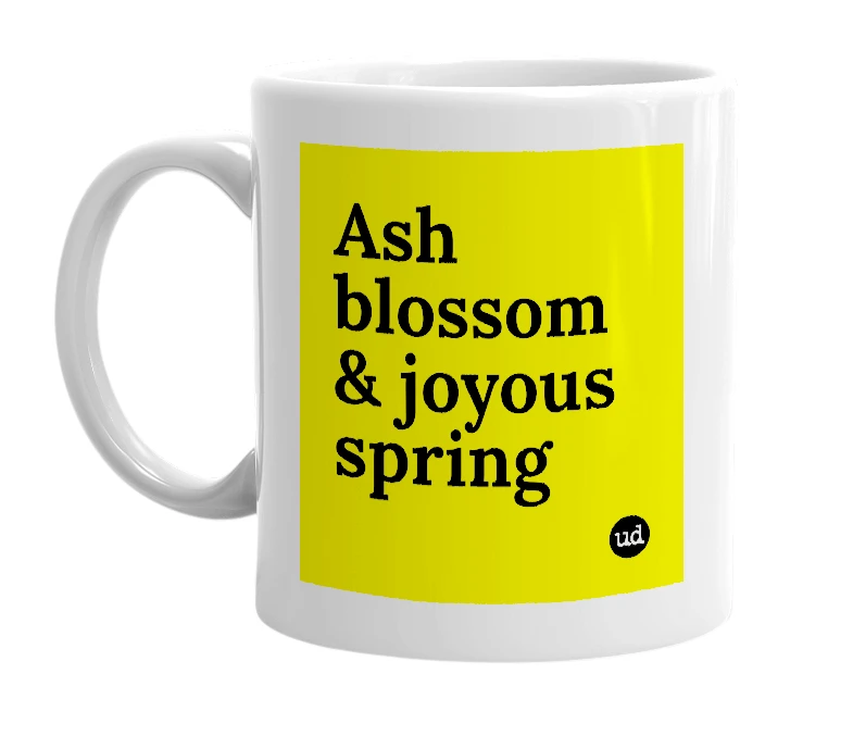 White mug with 'Ash blossom & joyous spring' in bold black letters