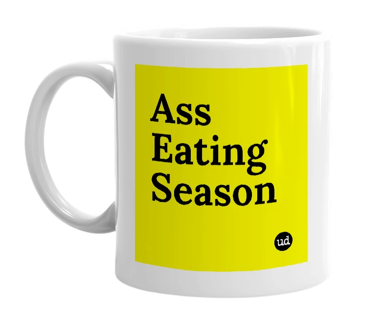White mug with 'Ass Eating Season' in bold black letters
