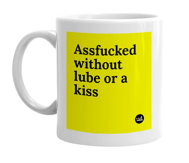 White mug with 'Assfucked without lube or a kiss' in bold black letters