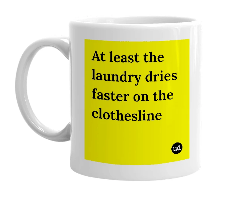 White mug with 'At least the laundry dries faster on the clothesline' in bold black letters