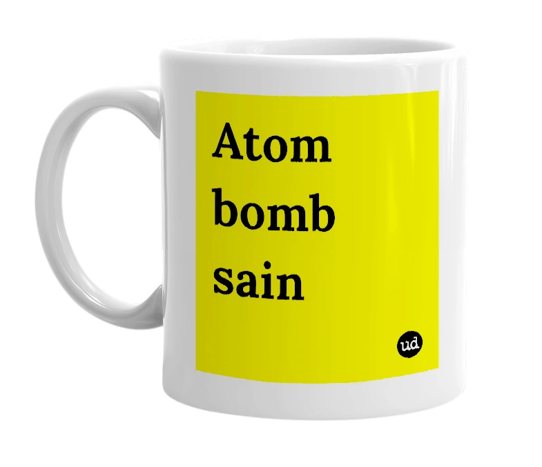 White mug with 'Atom bomb sain' in bold black letters