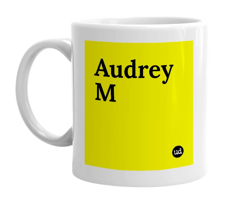 White mug with 'Audrey M' in bold black letters
