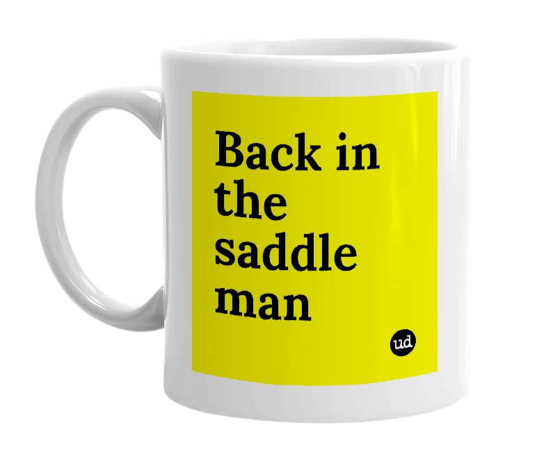 White mug with 'Back in the saddle man' in bold black letters